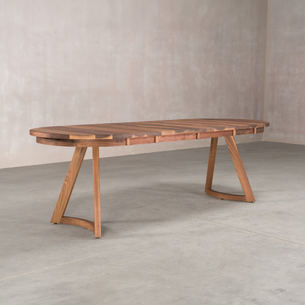 oval extendable Walnut table 36” wide x 60” long, with 2-18” leaves finished in Pure D on Chesbro legs