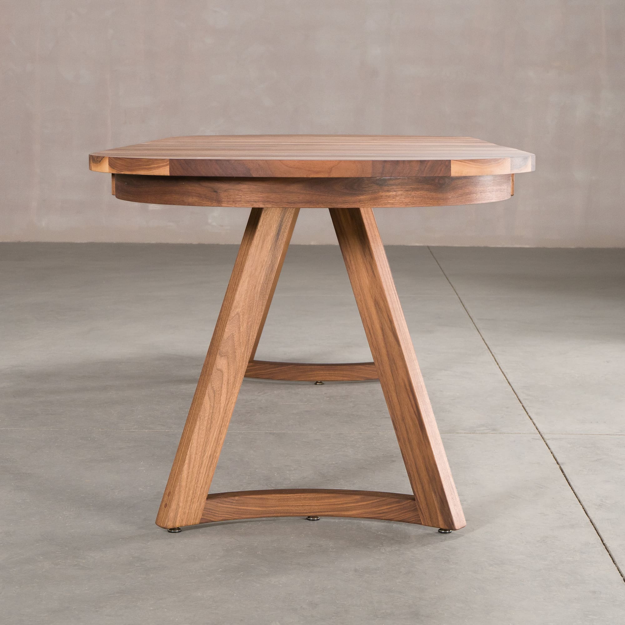 end view of oval extendable Walnut table finished in Pure D on Chesbro legs