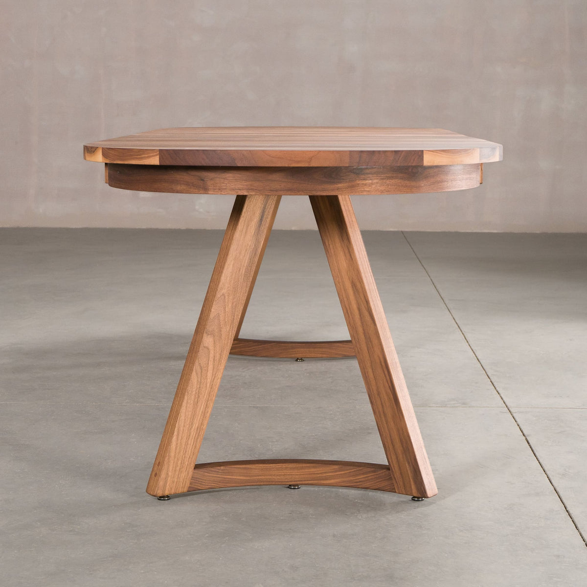 end view of oval extendable Walnut table finished in Pure D on Chesbro legs