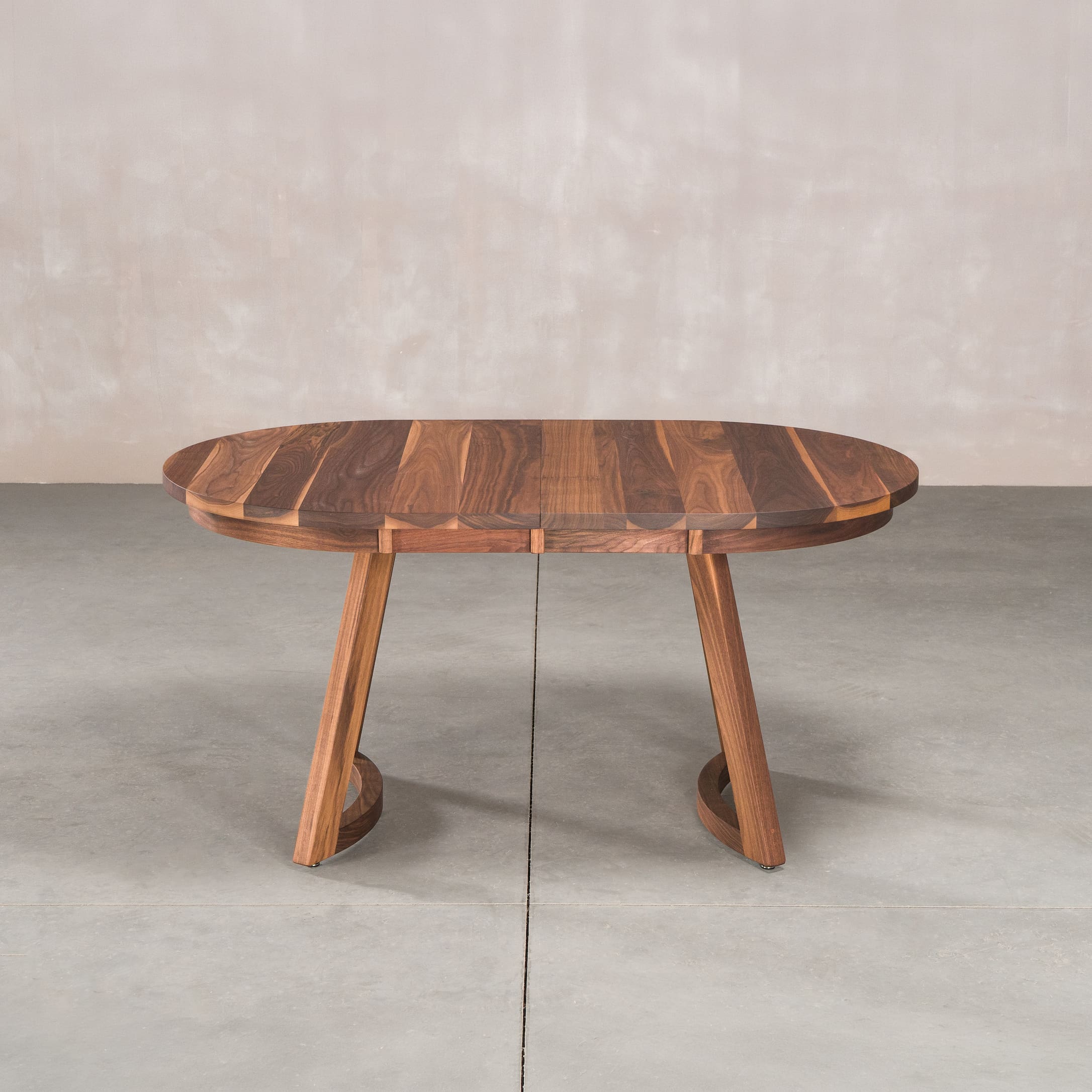 oval extendable Walnut table 36” wide x 60” long, finished in Pure D on Chesbro legs