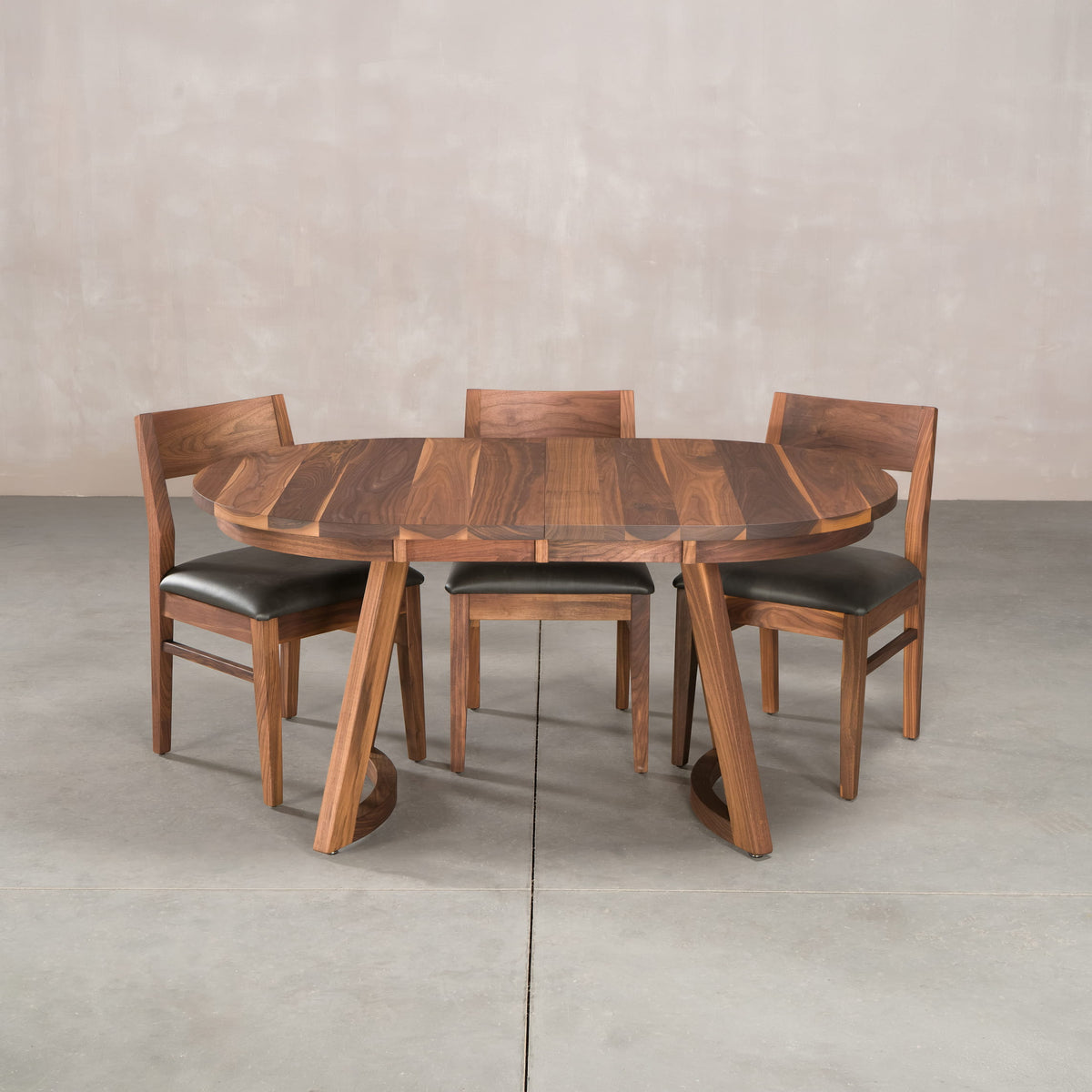 oval extendable Walnut table 36” wide x 60” long finished in Pure D on Chesbro legs shown with Aubrey chairs