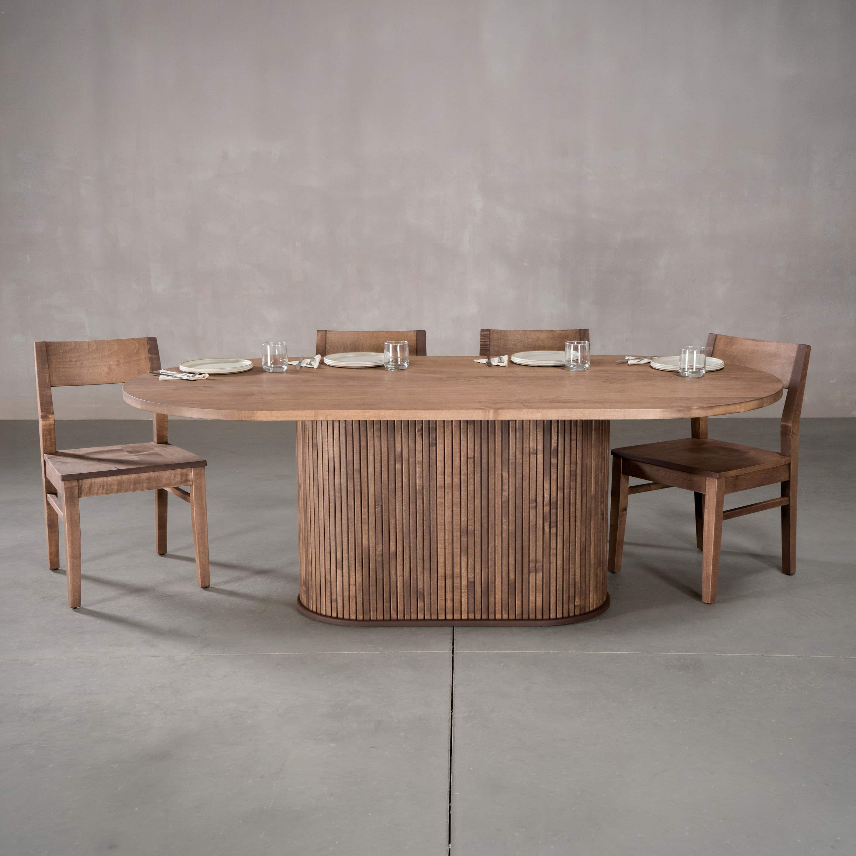 racetrack oval Maple table 42” wide x 84” long, finished in Coconut W on oval Como pedestal base; shown with Aubrey chairs