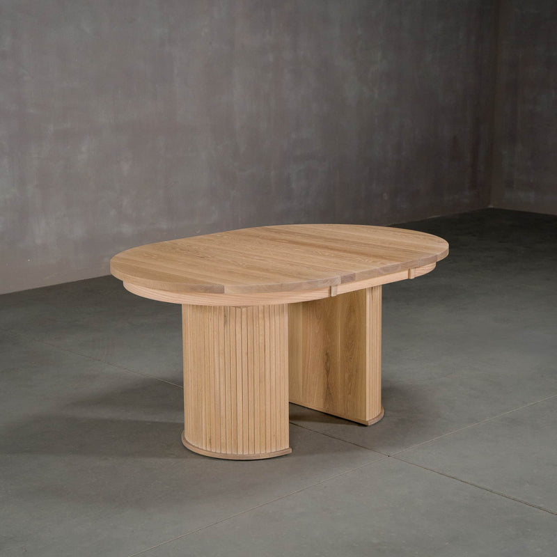 round extendable White Oak table 42” wide x 42” long, with 1-18” leaf finished in Clear D on Split Como base