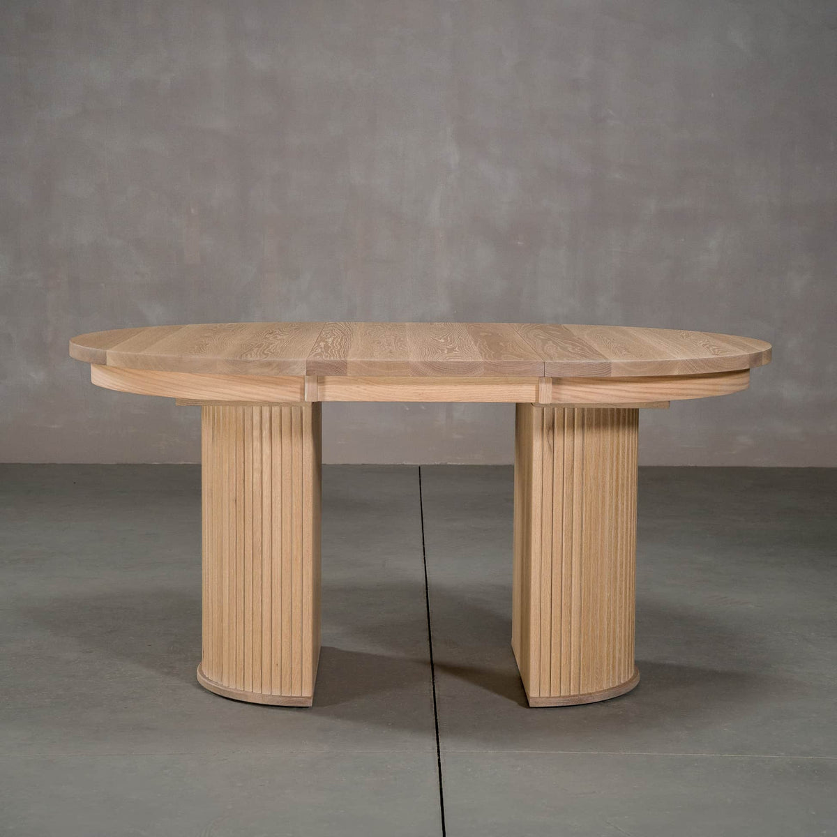 round extendable White Oak table 42” wide x 42” long, with 1-18” leaf finished in Clear D on Split Como base