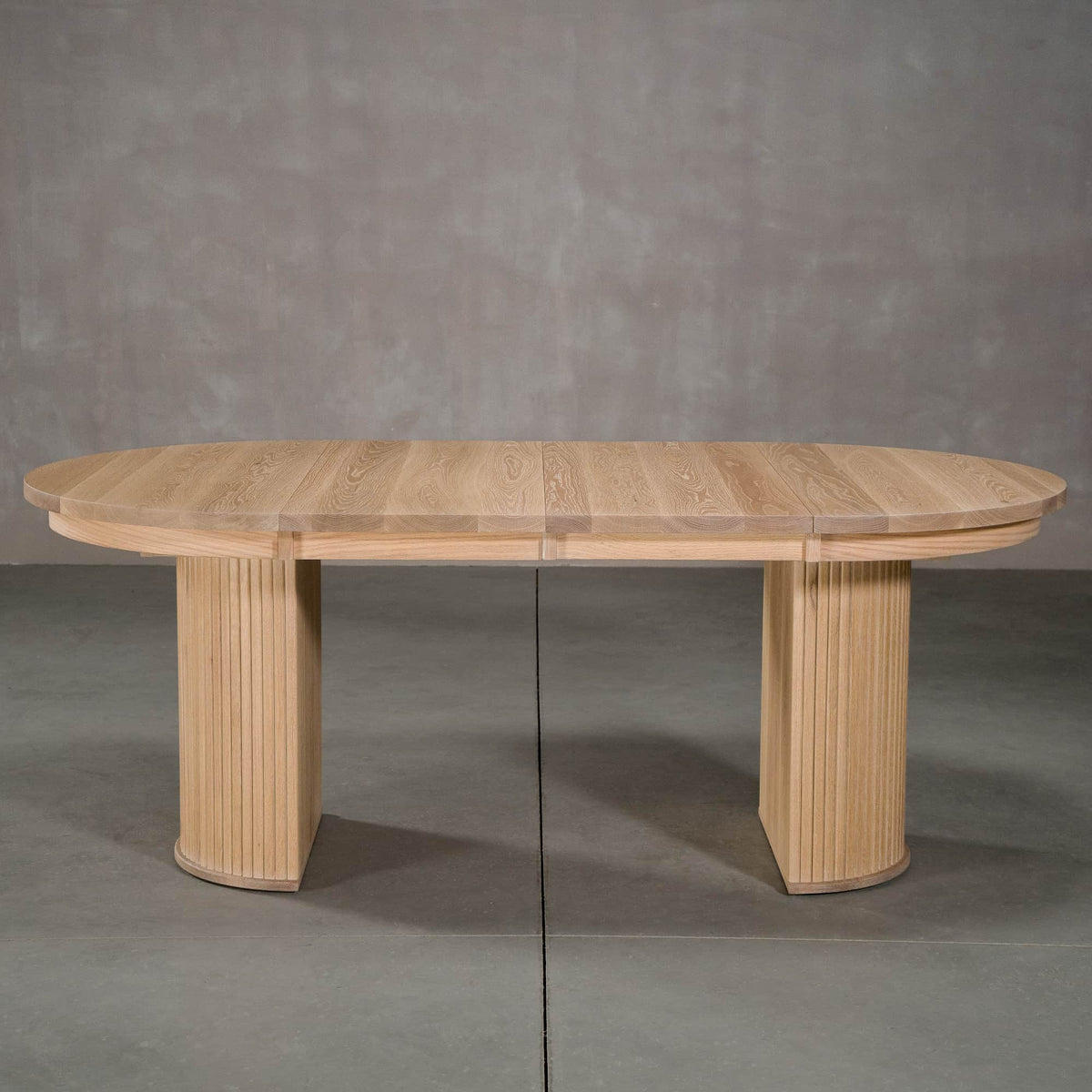 round extendable White Oak table 42” wide x 42” long, with 2-18” leaves finished in Clear D on Split Como base