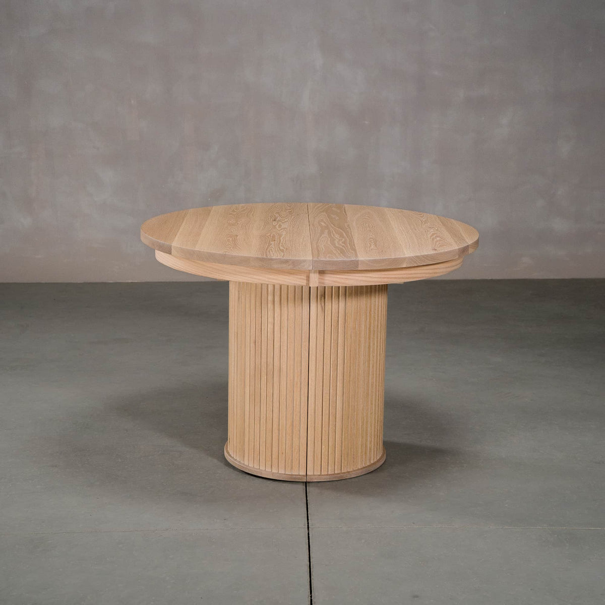 round extendable White Oak table 42” wide x 42” long, finished in Clear D on Split Como base