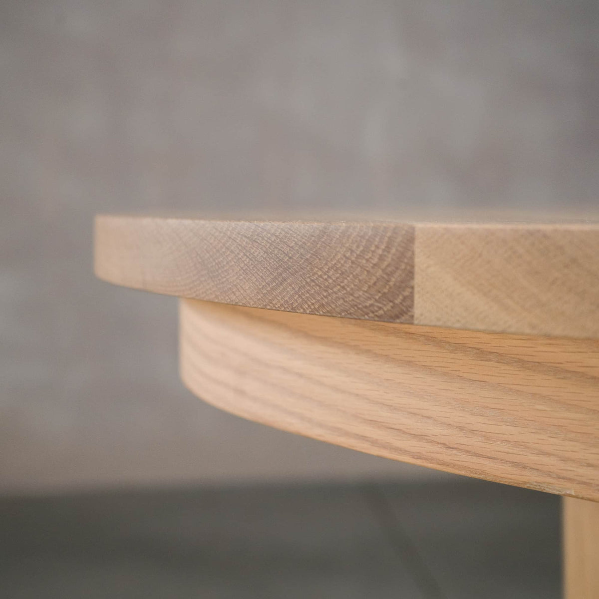 close up detail of the Seymour edge on a round Oak table finished in Clear D