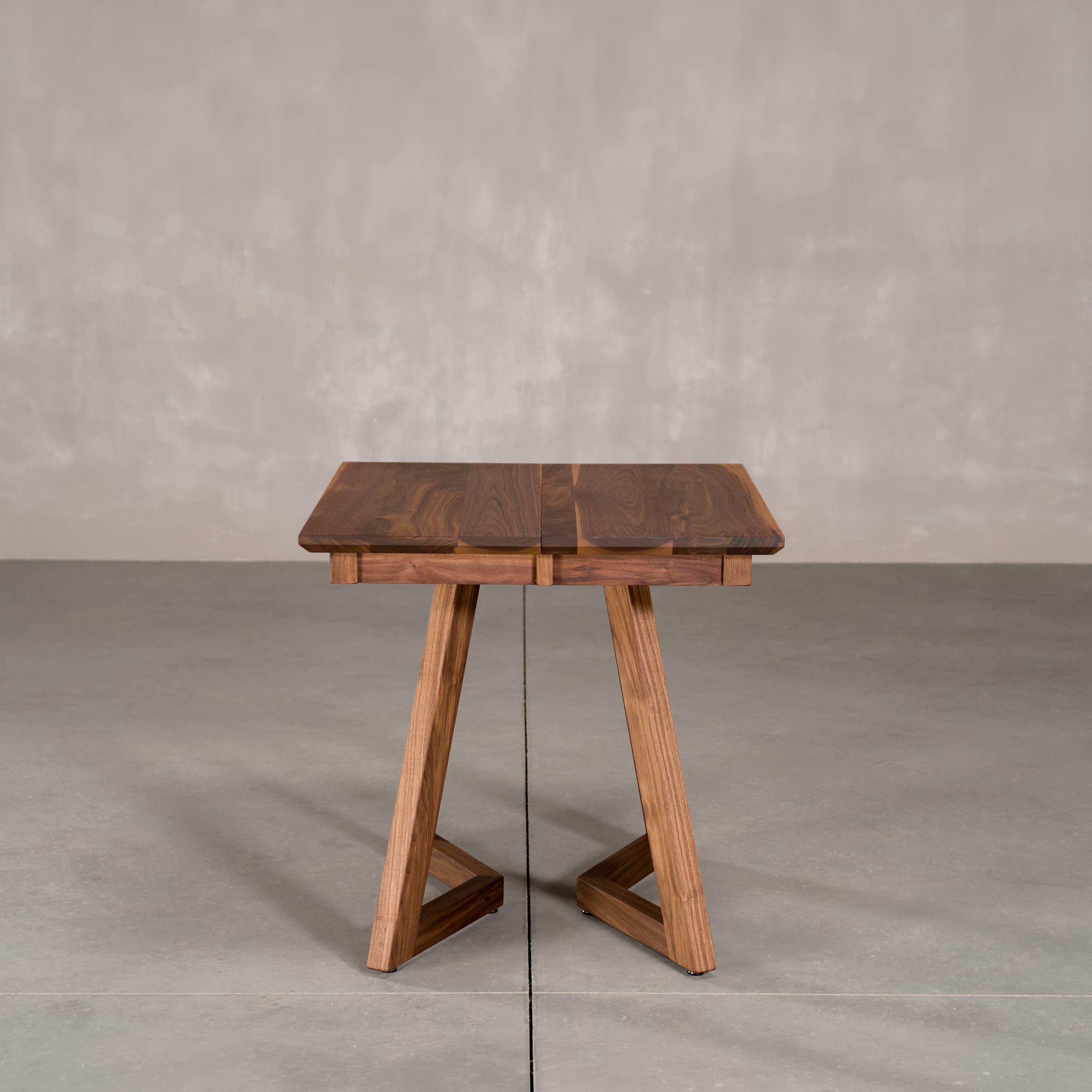square extendable Walnut table 30” wide x 30” long, finished in Pure D on Caldwell legs 