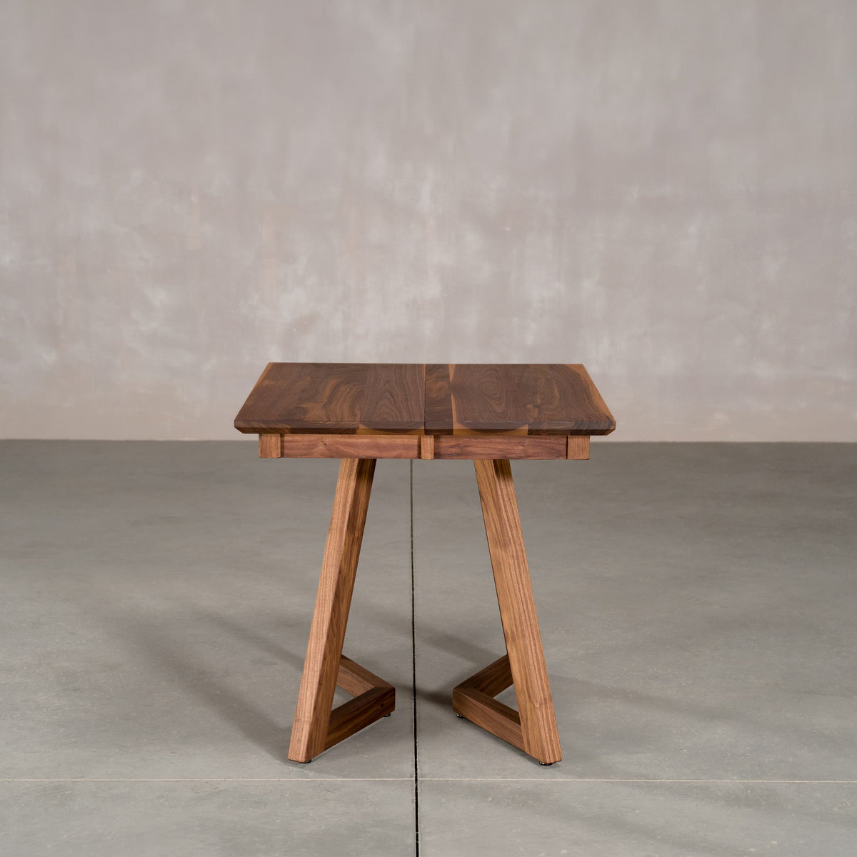 square extendable Walnut table 30” wide x 30” long, finished in Pure D on Caldwell legs 