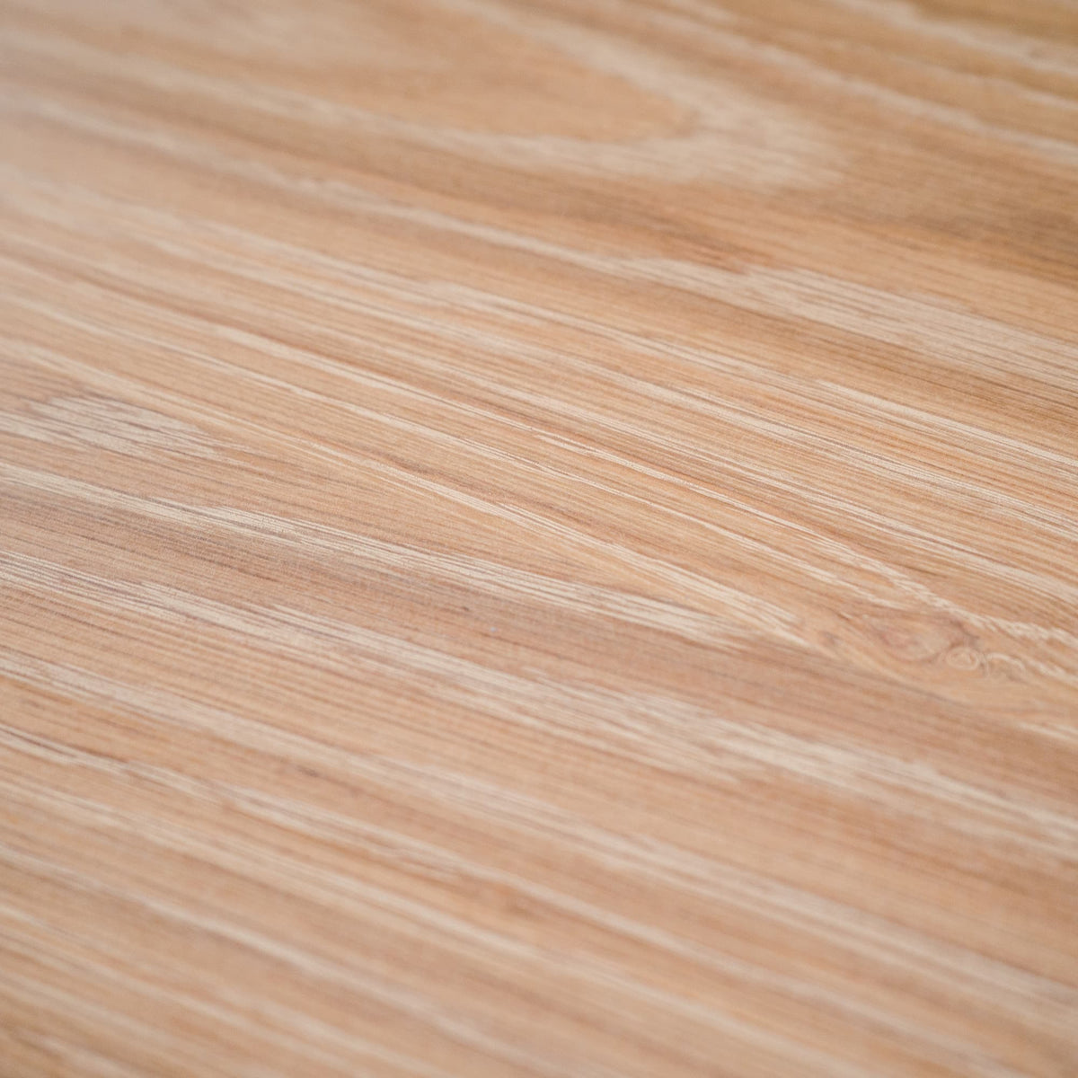 close up of the grain and color of an oval White Oak table finished in Clear D 