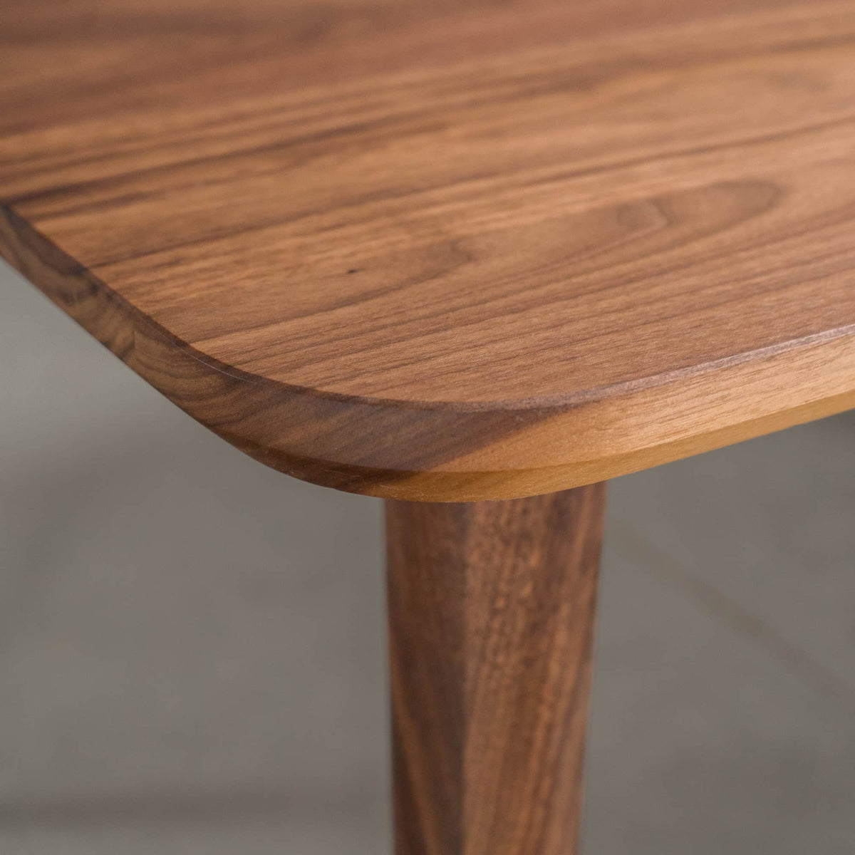 beveled Finlay edge on a rectangular Walnut table finished in Pure D on Milford base

