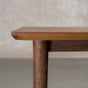 profile of the Finlay edge on a rectangular Walnut table 42” wide x 72” long, finished in Pure D on Milford base
