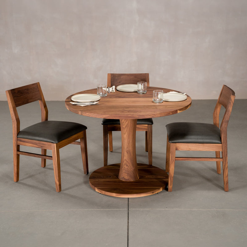 round Walnut table 42” wide x 42” long, finished in Pure D on Jennings pedestal base shown with Aubrey chairs
