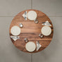 seating for 4 at a round Walnut table 42” wide x 42” long, finished in Pure D 