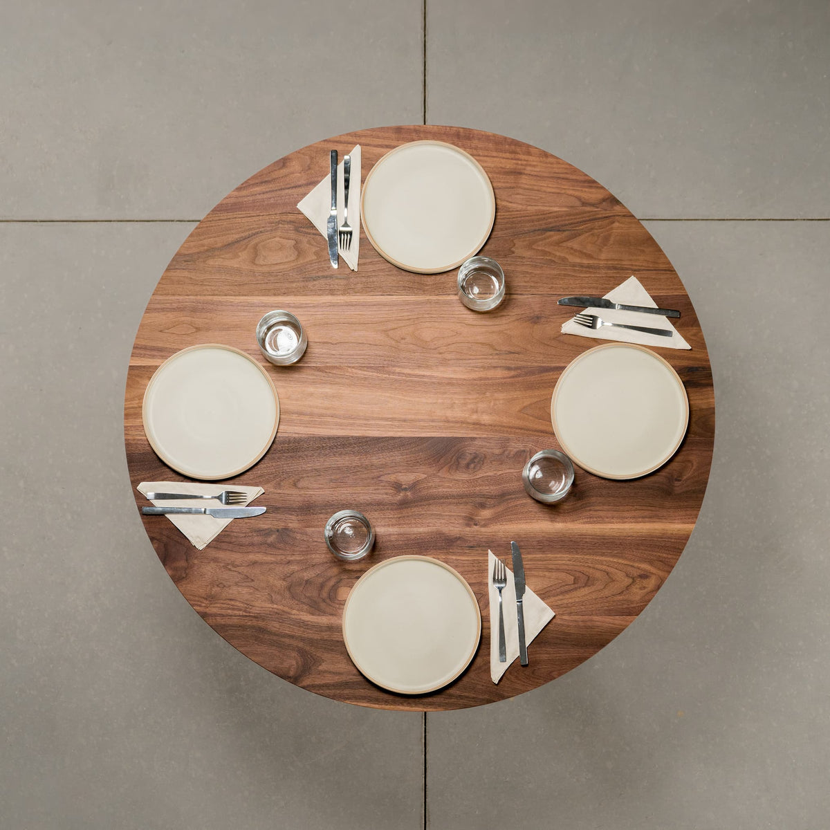 seating for 4 at a round Walnut table 42” wide x 42” long, finished in Pure D 