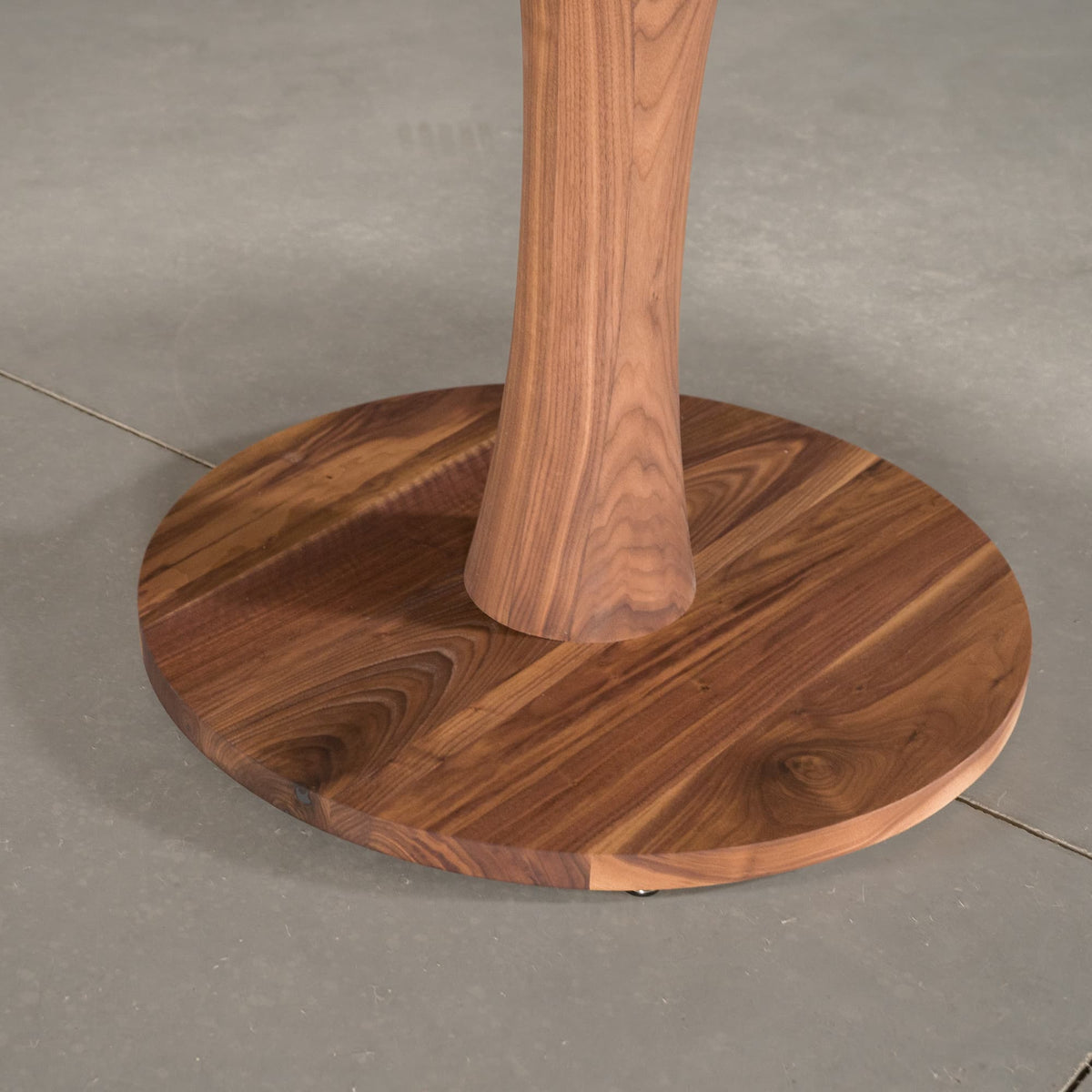 the Jennings pedestal base on a round Walnut table finished in Pure D 