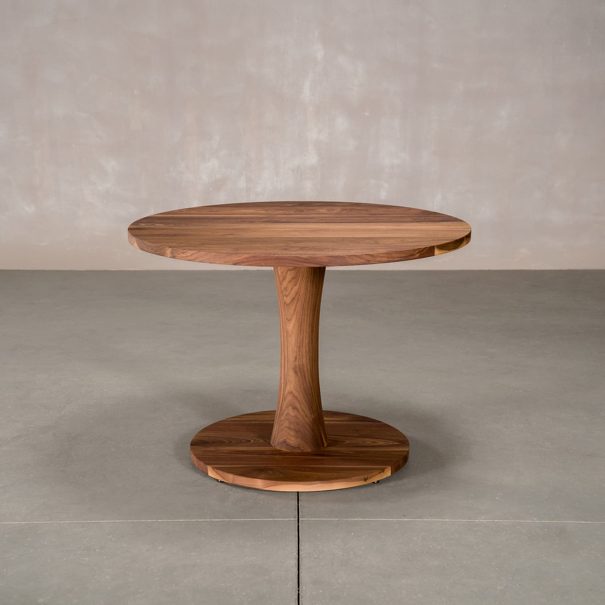 round Walnut table 42” wide x 42” long, finished in Pure D on Jennings pedestal base