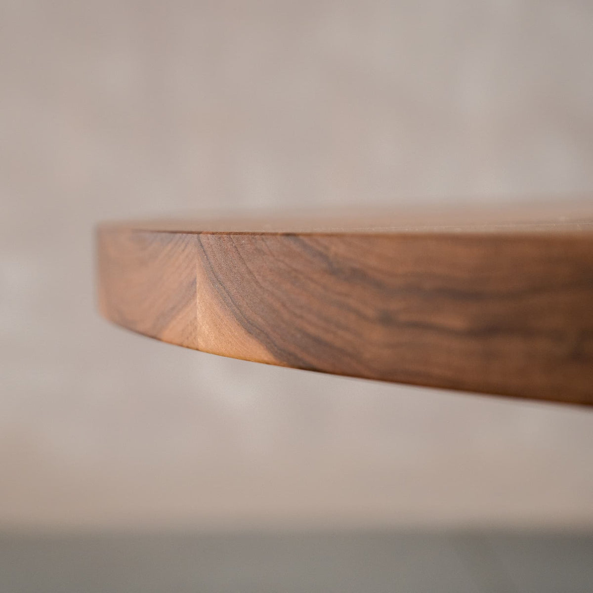the square Seymour edge on a round Walnut table finished in Pure D 