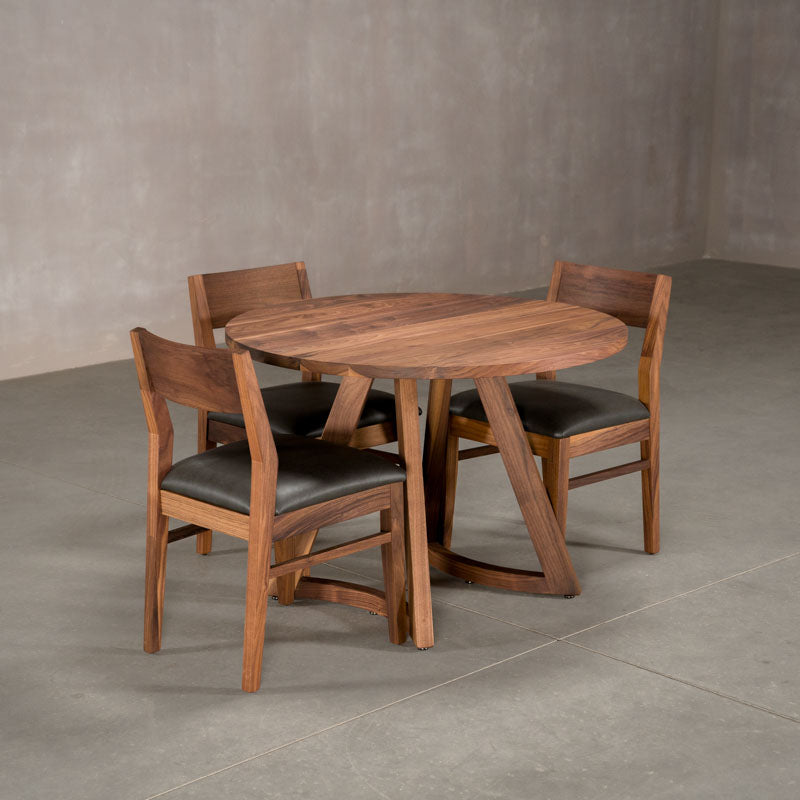 round  Walnut table 42” wide x 42” long, finished in Pure D on Chesbro legs shown with Walnut Aubrey chairs