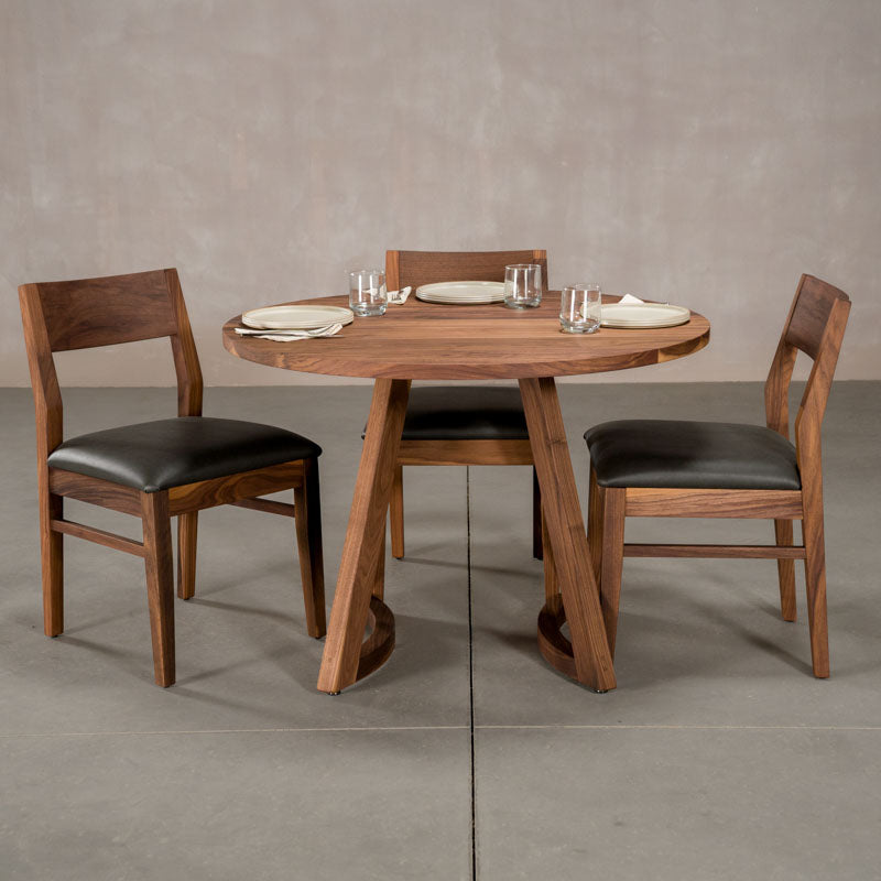 round  Walnut table 42” wide x 42” long, finished in Pure D on Chesbro legs shown with Walnut Aubrey chairs