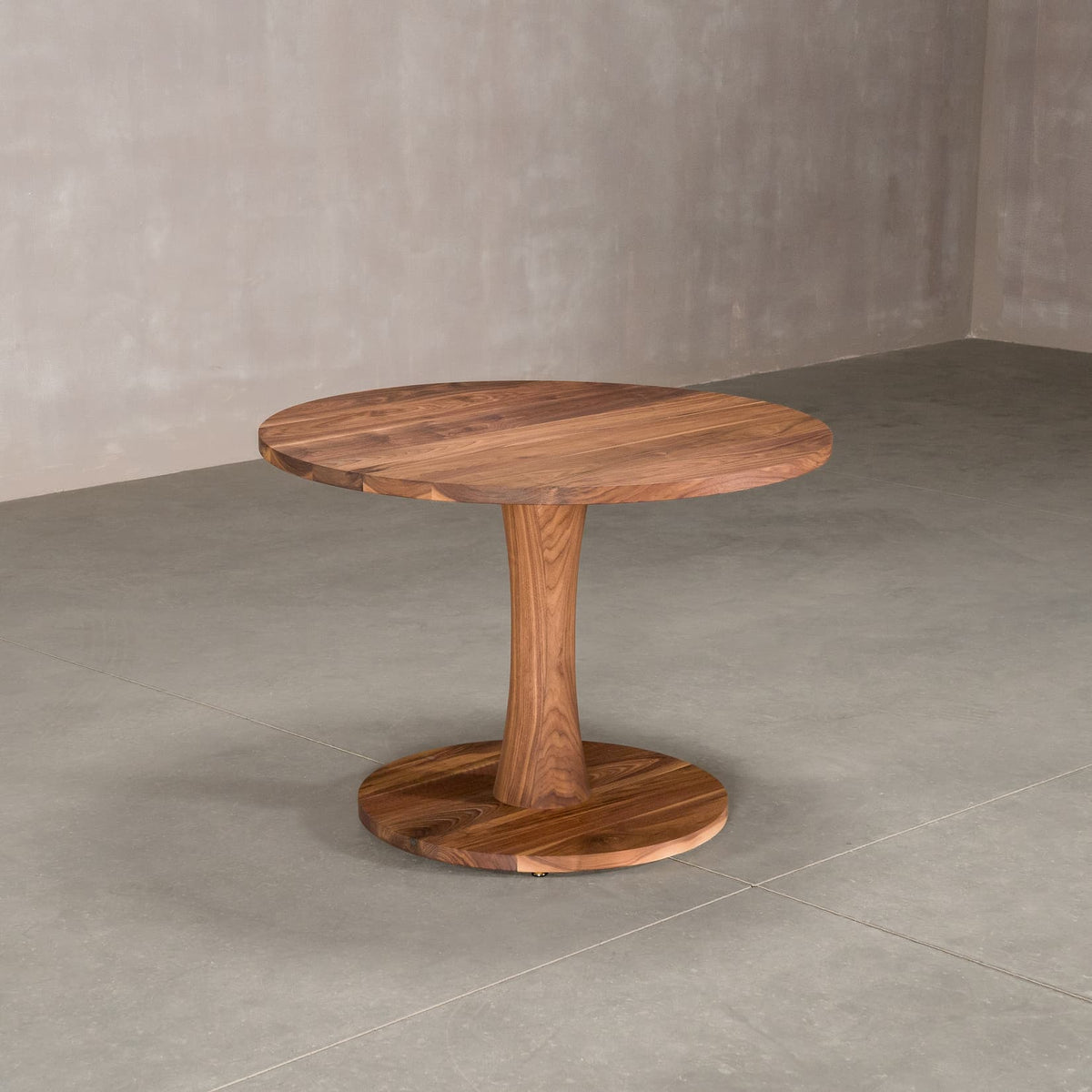 round Walnut table 42” wide x 42” long, finished in Pure D on Jennings pedestal base