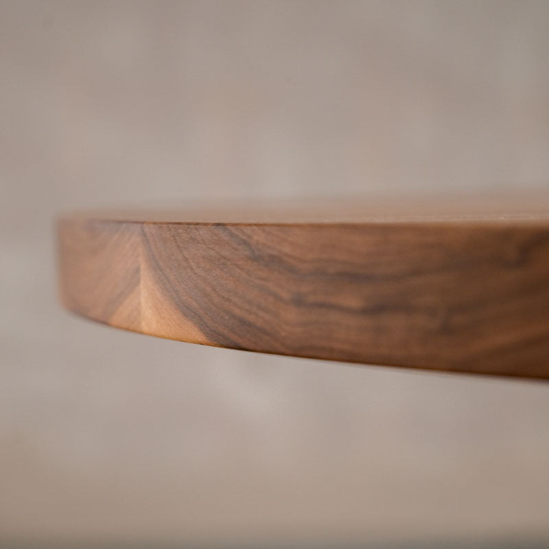 close up of the Seymour edge on a round  Walnut table 42” wide x 42” long, finished in Pure D 