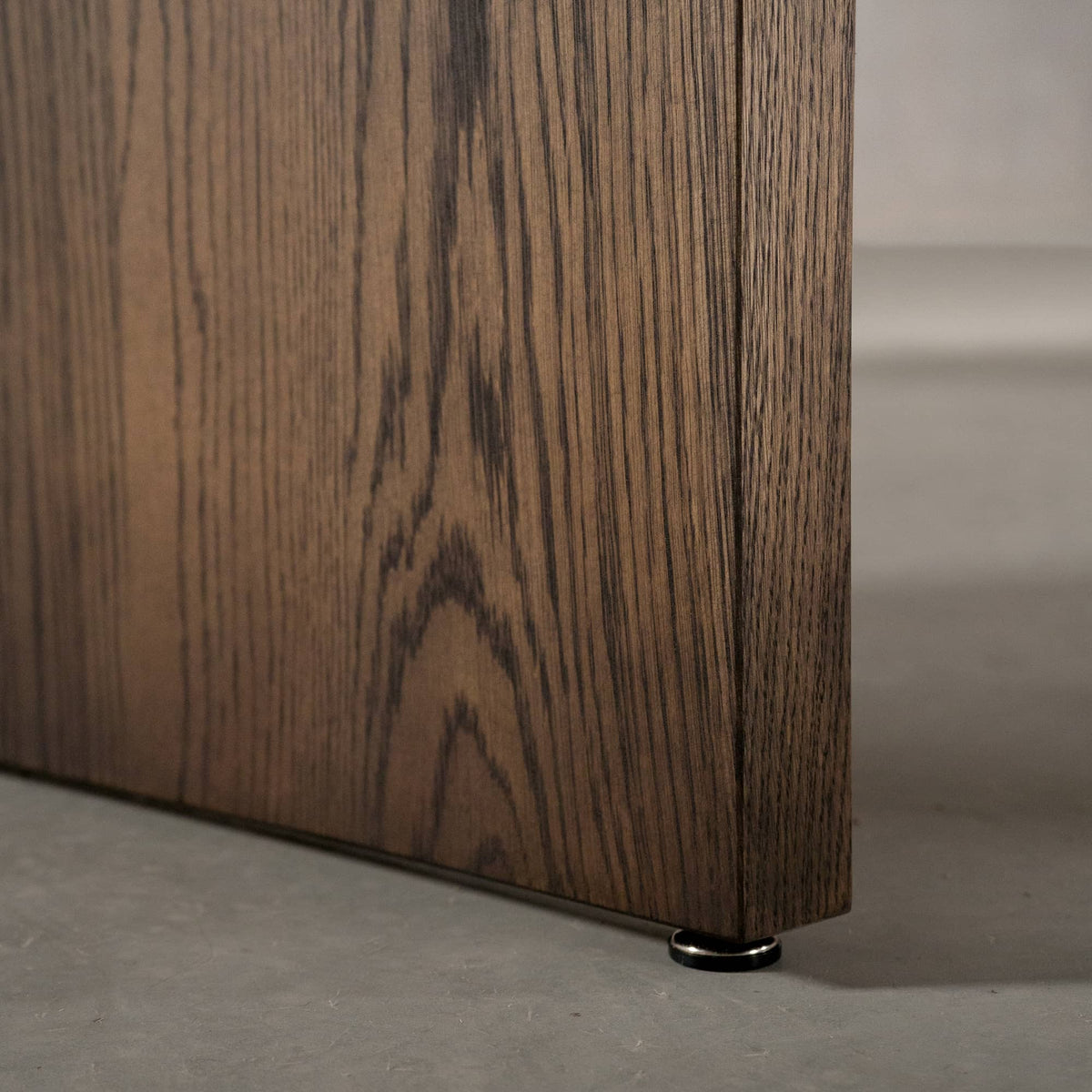 panel leg detail of the Panuke trestle base on a racetrack oval White Oak table finished in Dark Roast D