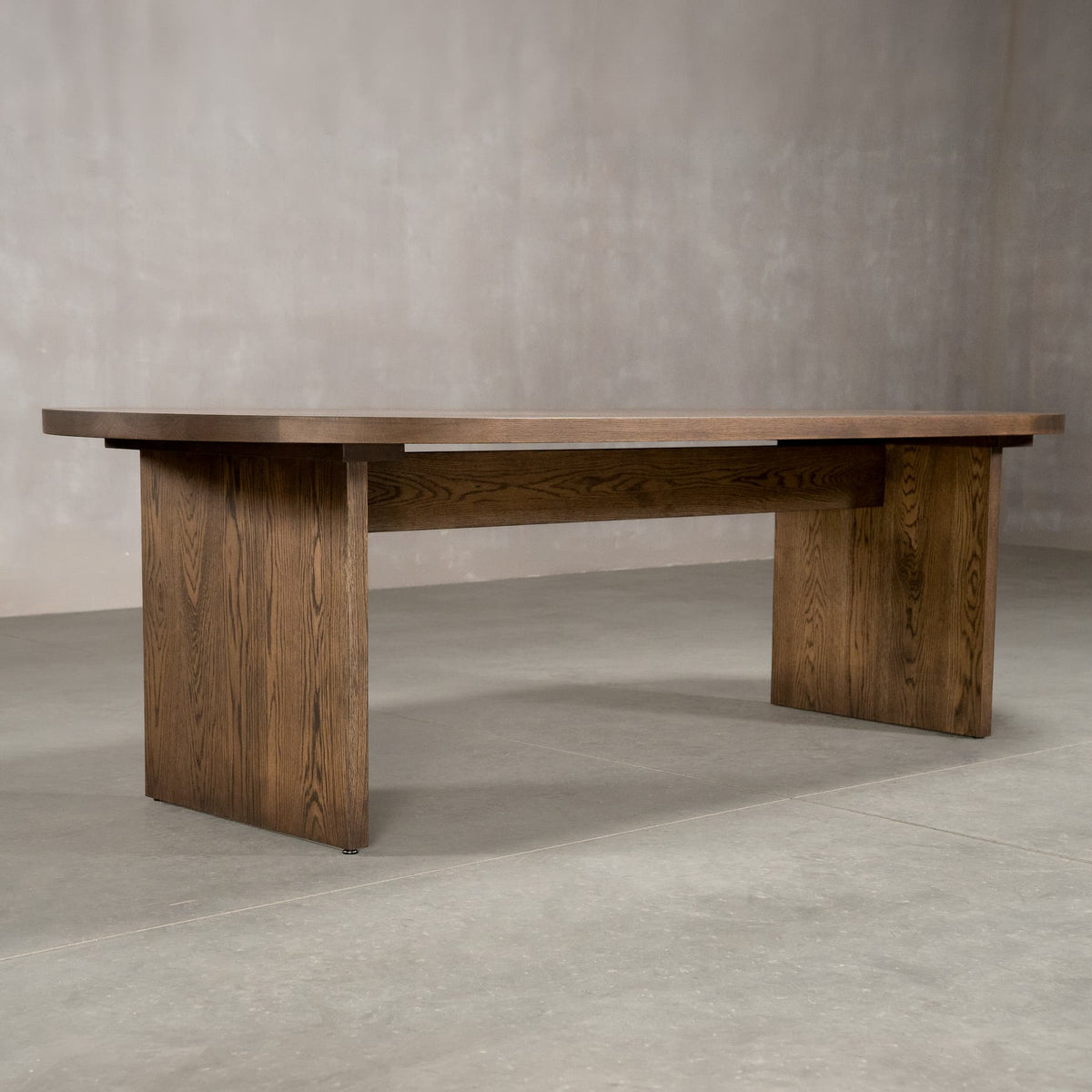 racetrack oval White Oak table 42” wide x 100” long, finished in Dark Roast D on Panuke Trestle base