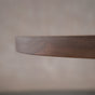 close up of the Seymour edge on an oval Walnut table finished in Cortado D 