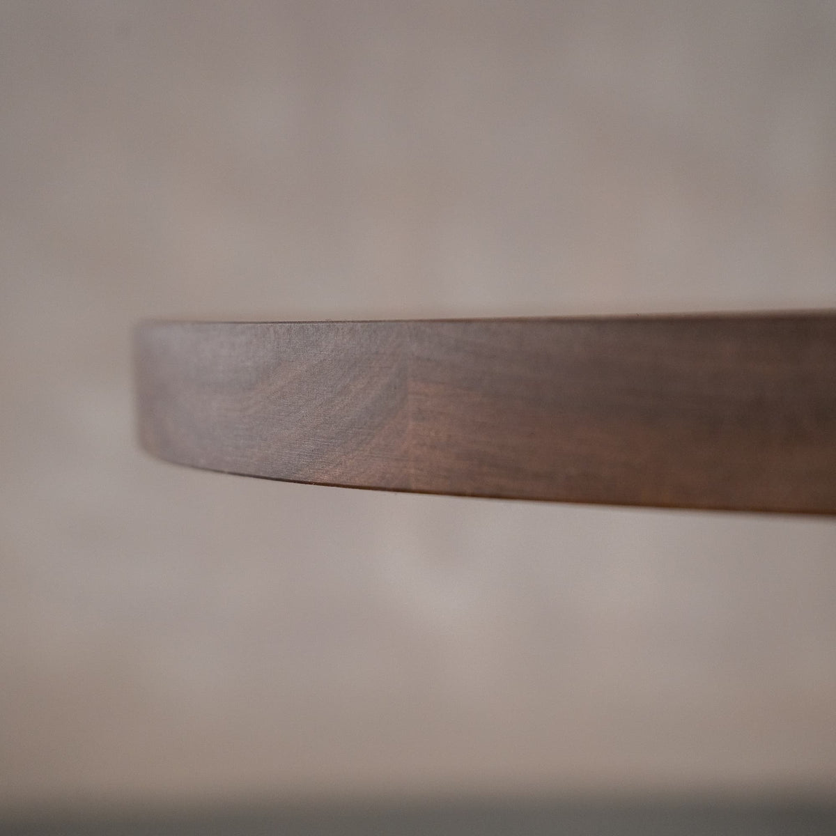 close up of the Seymour edge on an oval Walnut table finished in Cortado D 