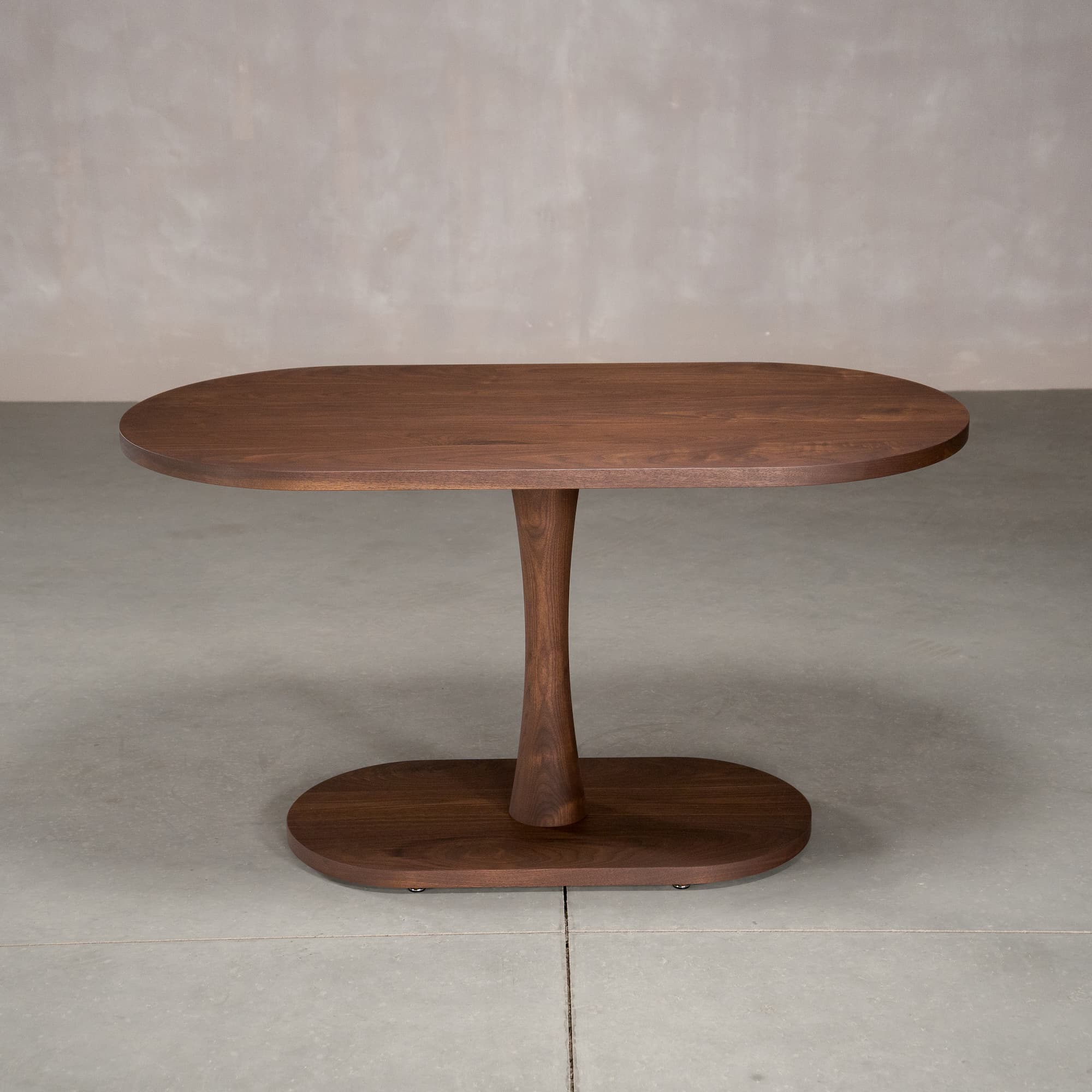 oval Walnut table 29” wide x 55” long, finished in Cortado D on a Jennings pedestal base