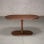 oval Walnut table 29” wide x 55” long, finished in Cortado D on a Jennings pedestal base