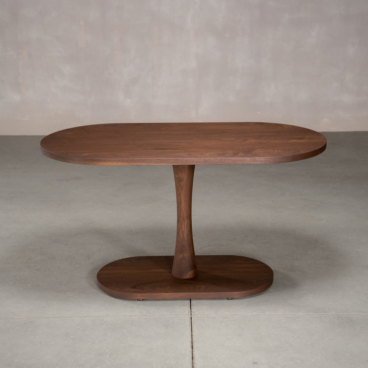 oval Walnut table 29” wide x 55” long, finished in Cortado D on a Jennings pedestal base
