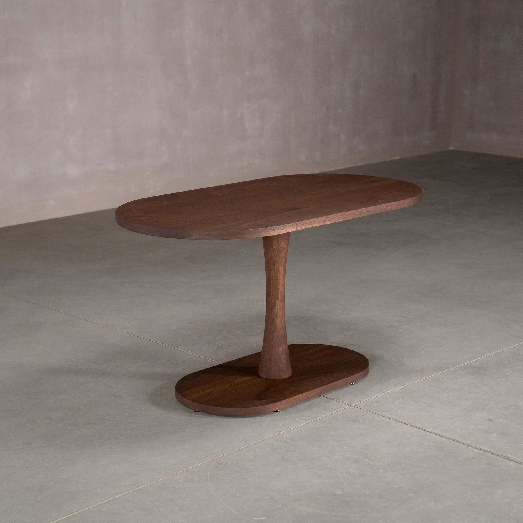 oval Walnut table 29” wide x 55” long, finished in Cortado D on a Jennings pedestal base