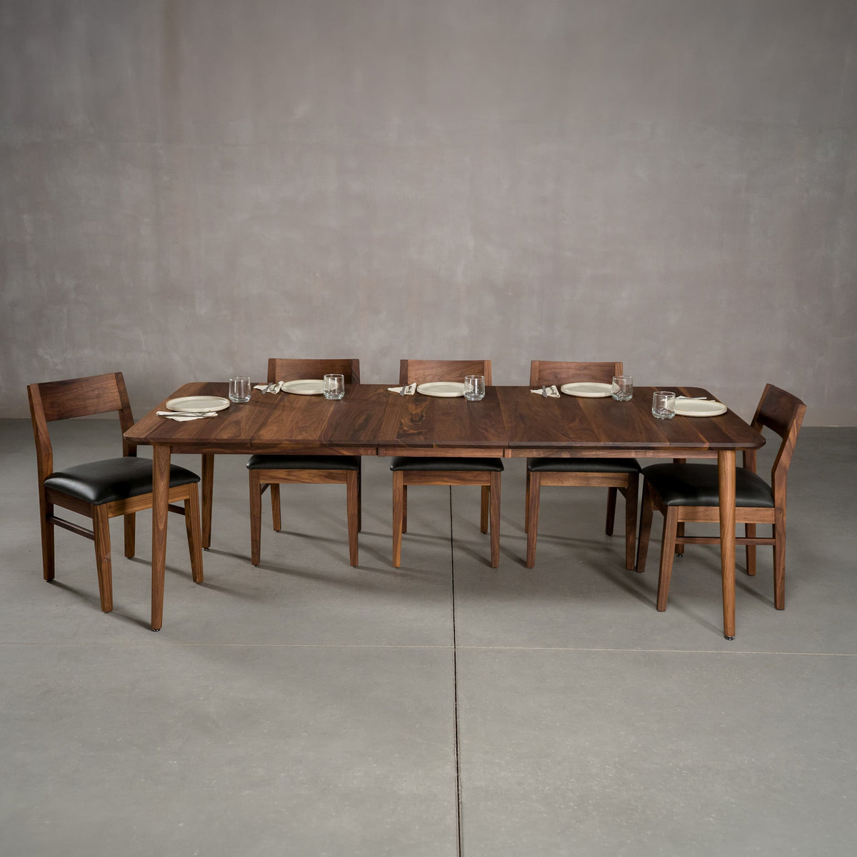 extended Walnut table 42” wide x 72” long, with 1-18” leaf finished in Pure D on Milford base