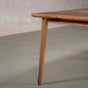 corner detail of a extendable Walnut table finished in Pure D on Milford base