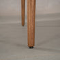 the tapered leg of a MIlford base in Walnut finished in Pure D