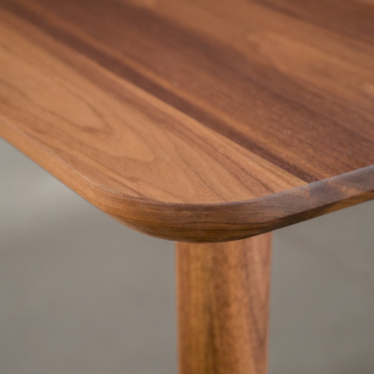 the Finlay edge on an extendable Walnut table finished in Pure D on Milford base