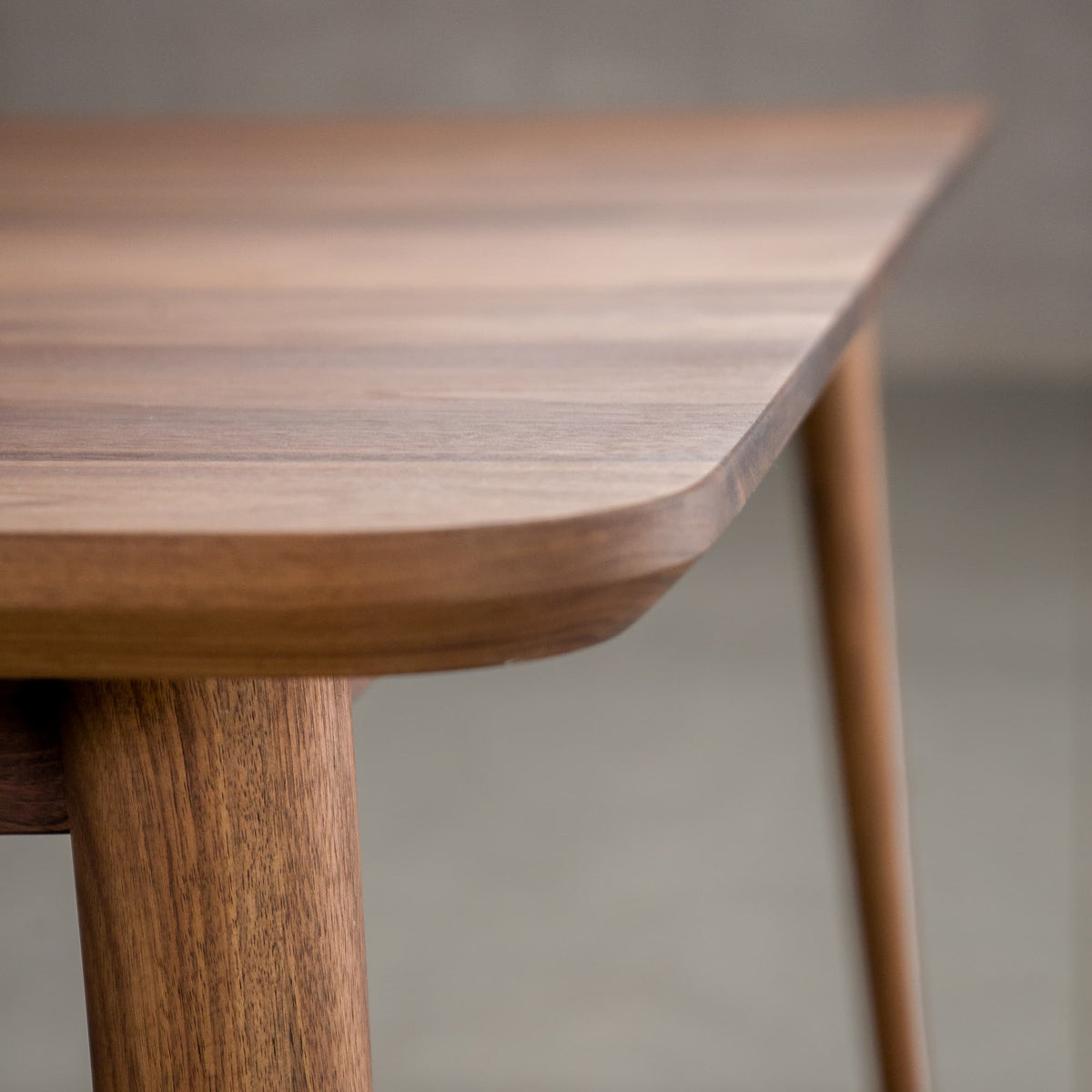 the Milford edge on an extendable Walnut table finished in Pure D on Milford base