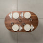 seating for 4 at an oval Walnut table 30” wide x 48” long, finished in Pure D 