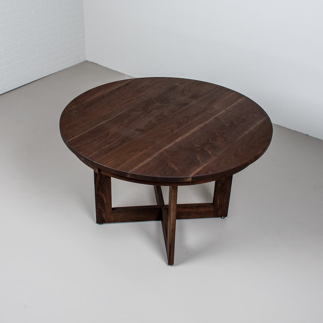 walnut round extension table on split base finished in Black D