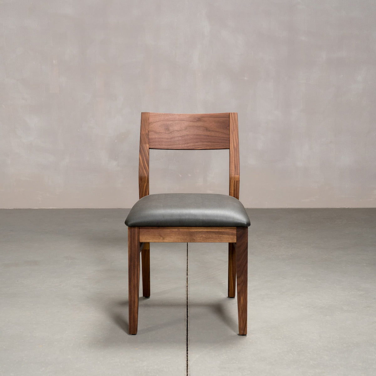 an Aubrey side chair in Walnut with a Thunder Leather seat