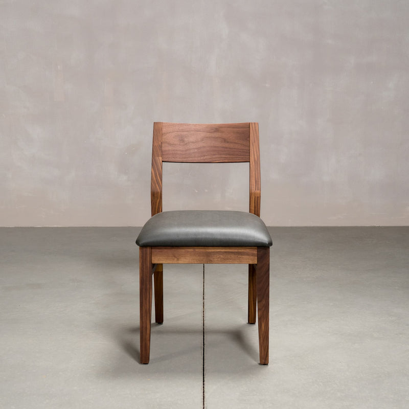 an Aubrey side chair in Walnut with a Thunder Leather seat