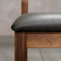 seat detail on an Aubrey side chair in Walnut with a Thunder Leather seat
