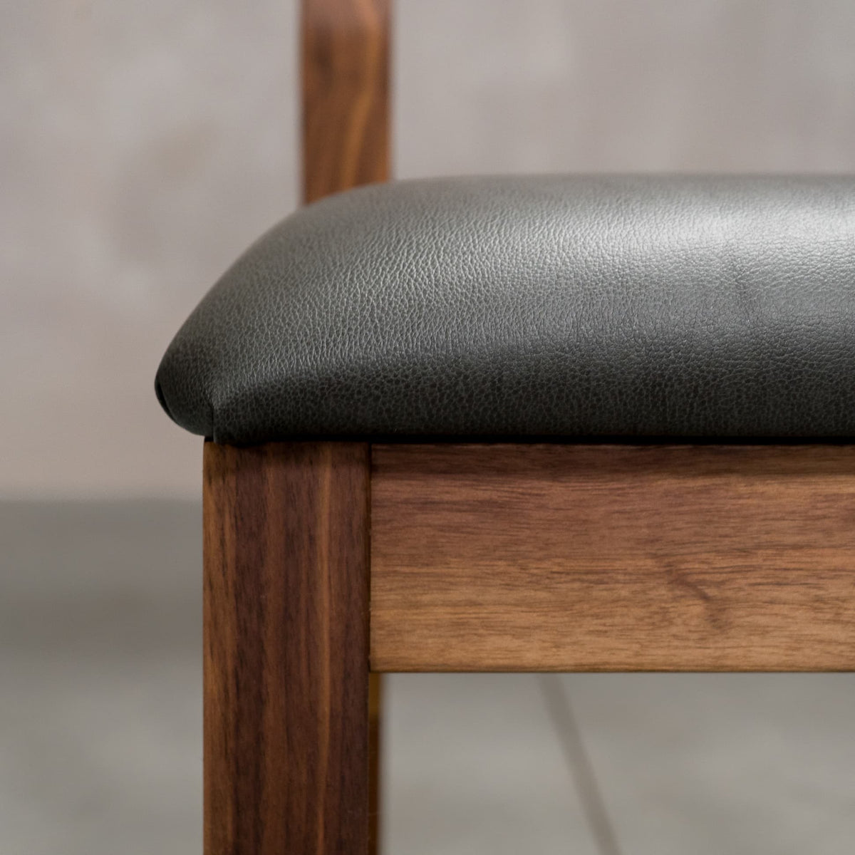seat detail on an Aubrey side chair in Walnut with a Thunder Leather seat