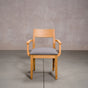 a White Oak Aubrey Armchair finished in Pure D with Graphite fabric seat