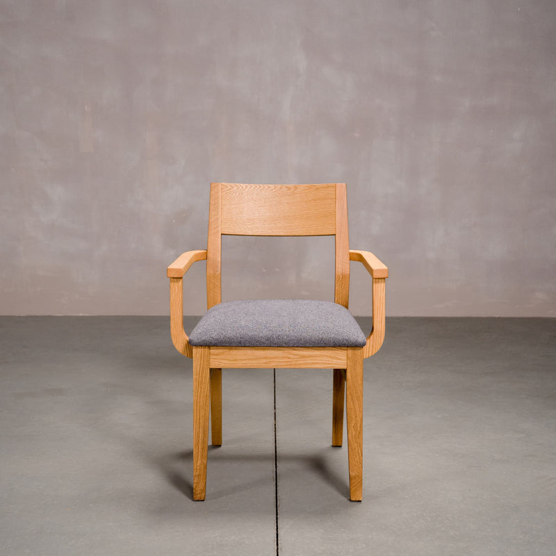 a White Oak Aubrey Armchair finished in Pure D with Graphite fabric seat