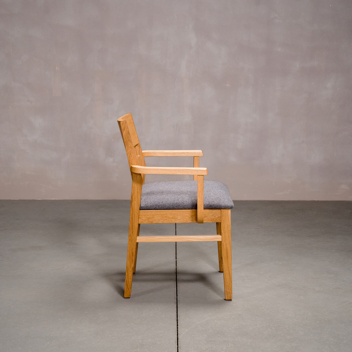 a White Oak Aubrey Armchair finished in Pure D with Graphite fabric seat
