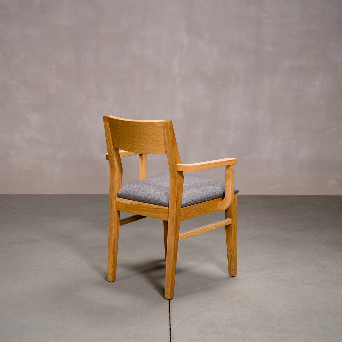 a White Oak Aubrey Armchair finished in Pure D with Graphite fabric seat