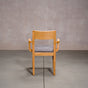 a White Oak Aubrey Armchair finished in Pure D with Graphite fabric seat